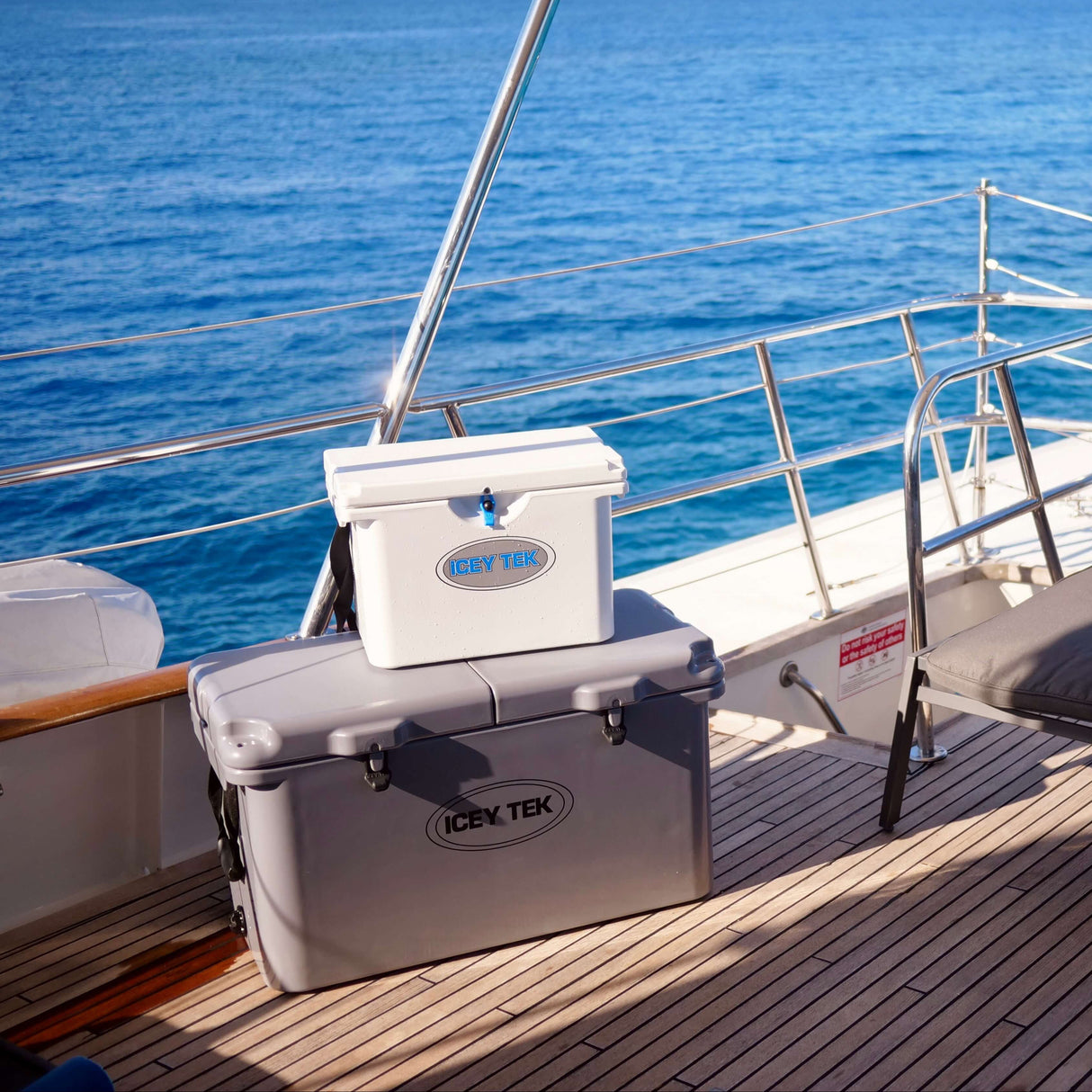 Coolers on a boat deck with ocean and sky in the background