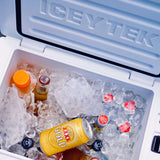 Ice chest with ice and drinks, branded 'ICEY TEK'.