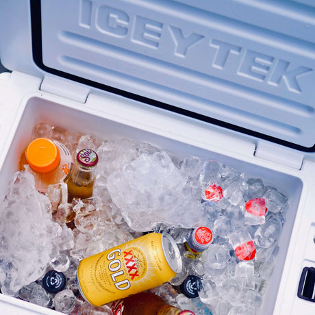Ice chest with ice and drinks, branded 'ICEY TEK'.