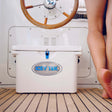 ICEY TEK cooler on a boat with a person's legs visible